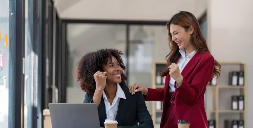 Corporate workers smiling and jubilating at work.